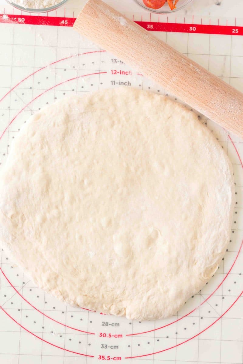 All-purpose dough recipe shaped into a pizza crust on a pastry mat before baking. Hostess At Heart