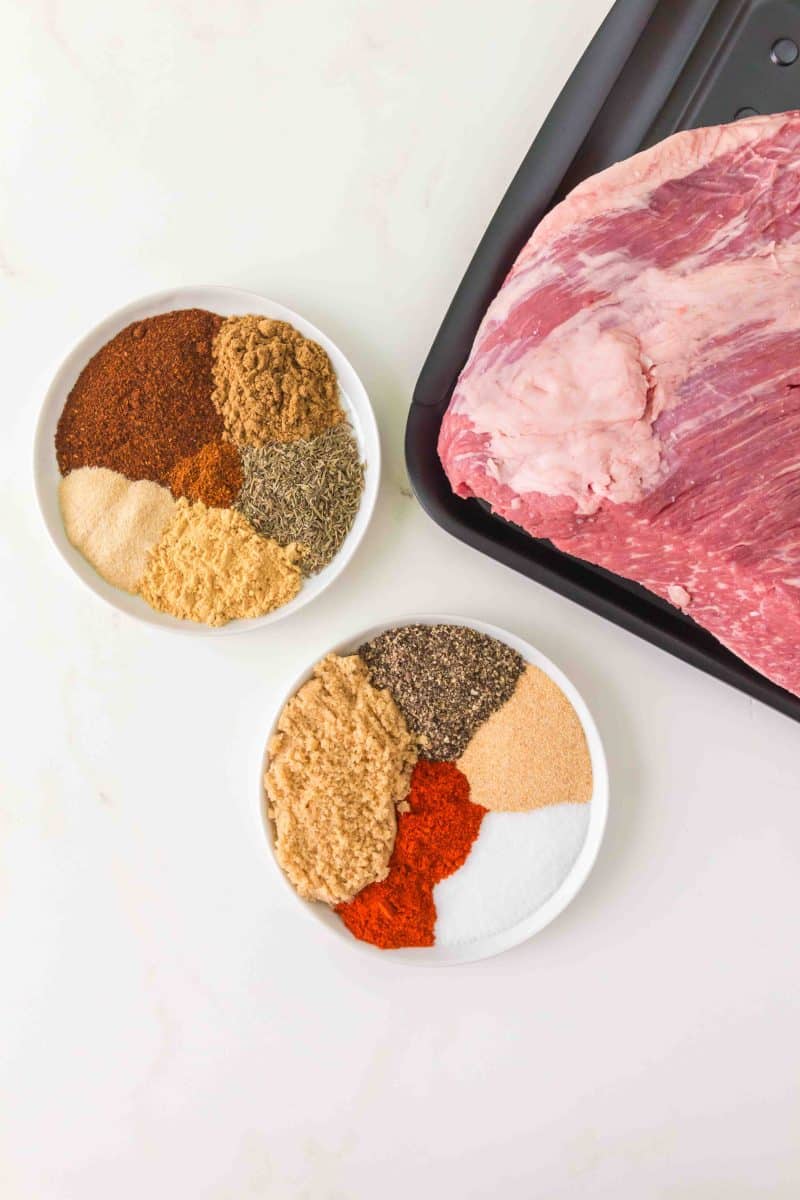 Two dishes filled with spices to make a dry rub recipe for a baked beef brisket. Hostess At Heart
