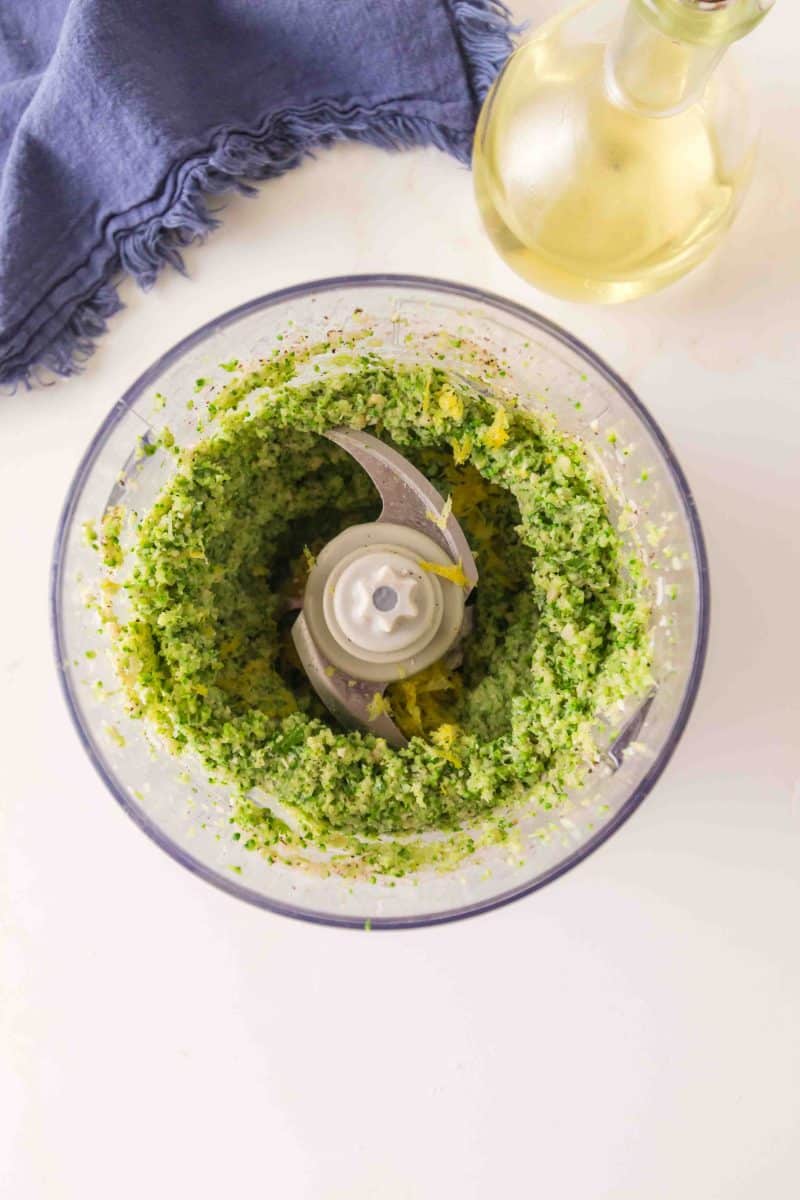 Overhead view of broccoli pesto sauce in a food processor. Hostess At Heart