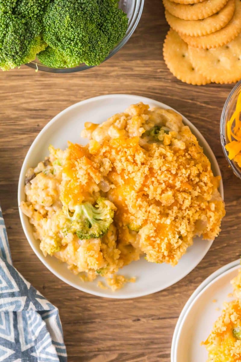 Overhead shot of a white plate filled with cheesy broccoli rice casserole with mushroom soup. Hostess At Heart
