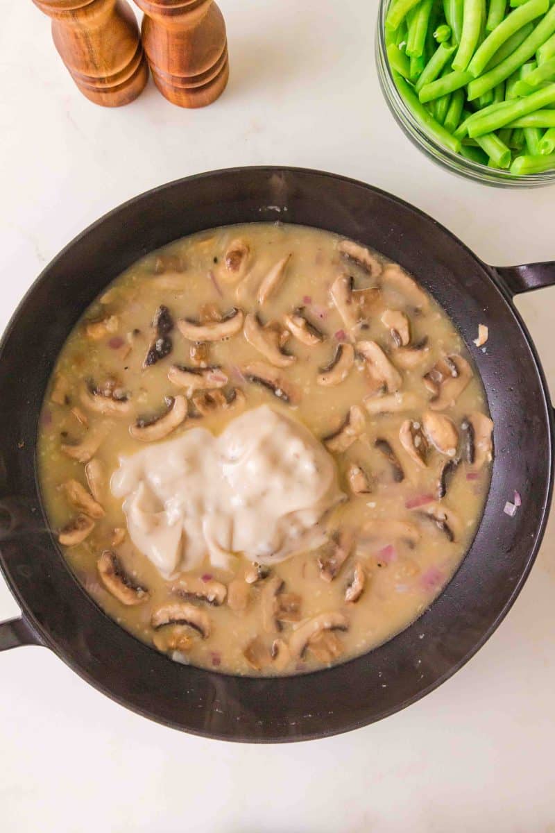 Cream of mushroom soup stirred into broth for homemade green bean casserole sauce. Hostess At Heart