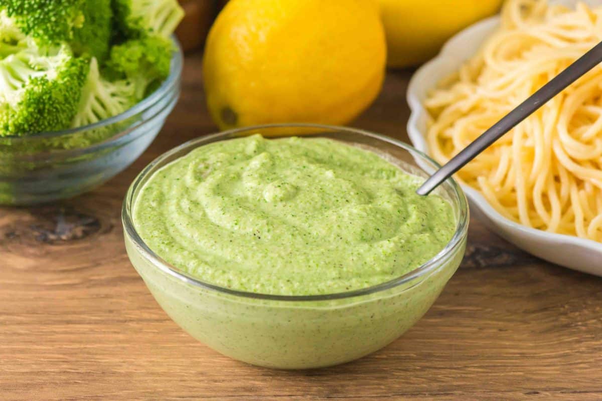 A glass bowl filled with homemade broccoli pesto sauce. Hostess At Heart