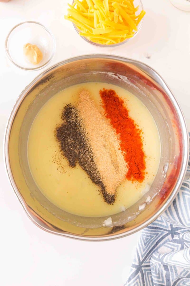 Cheese sauce with cream of mushroom soup topped with spices in a saucepan. Hostess At Heart