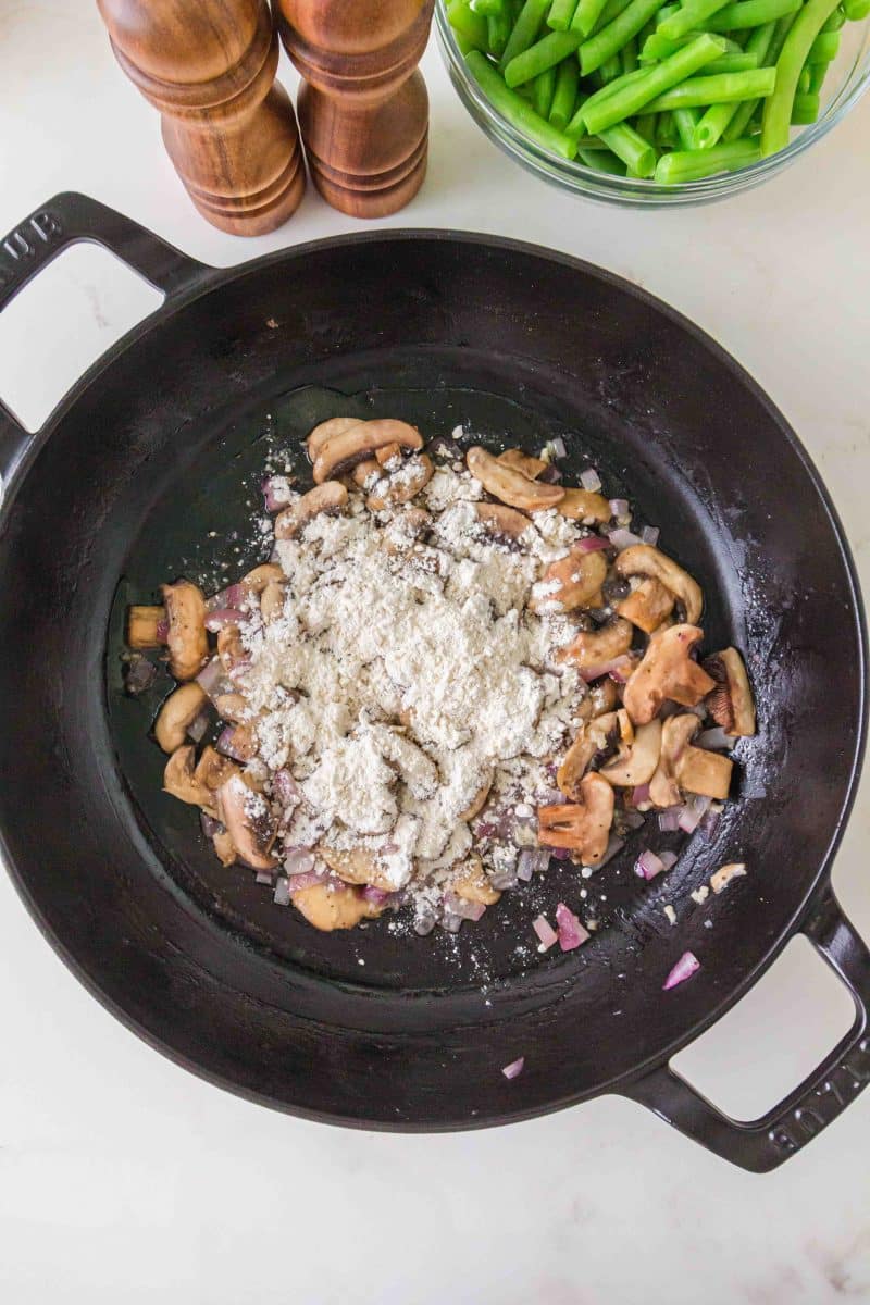 Flour sprinkled over mushrooms and onions to thicken green bean casserole sauce. Hostess At Heart