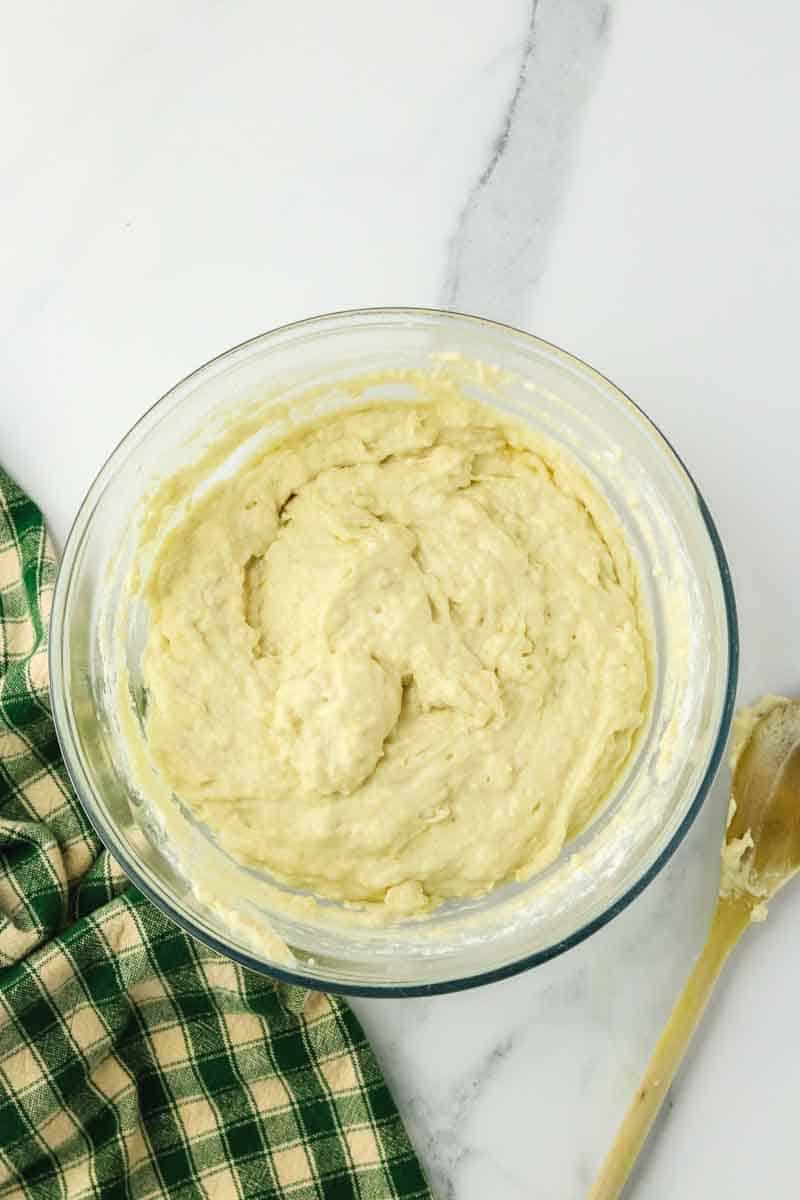 Zucchini cheese bread batter in a glass mixing bowl. Hostess At Heart