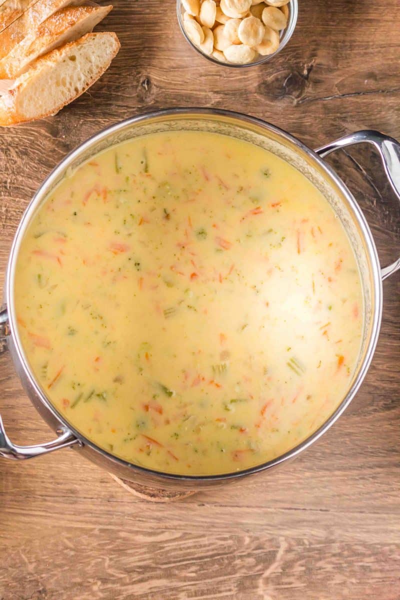 Overhead shot of a finished pot of creamy broccoli cheddar soup in a soup pot. Hostess At Heart