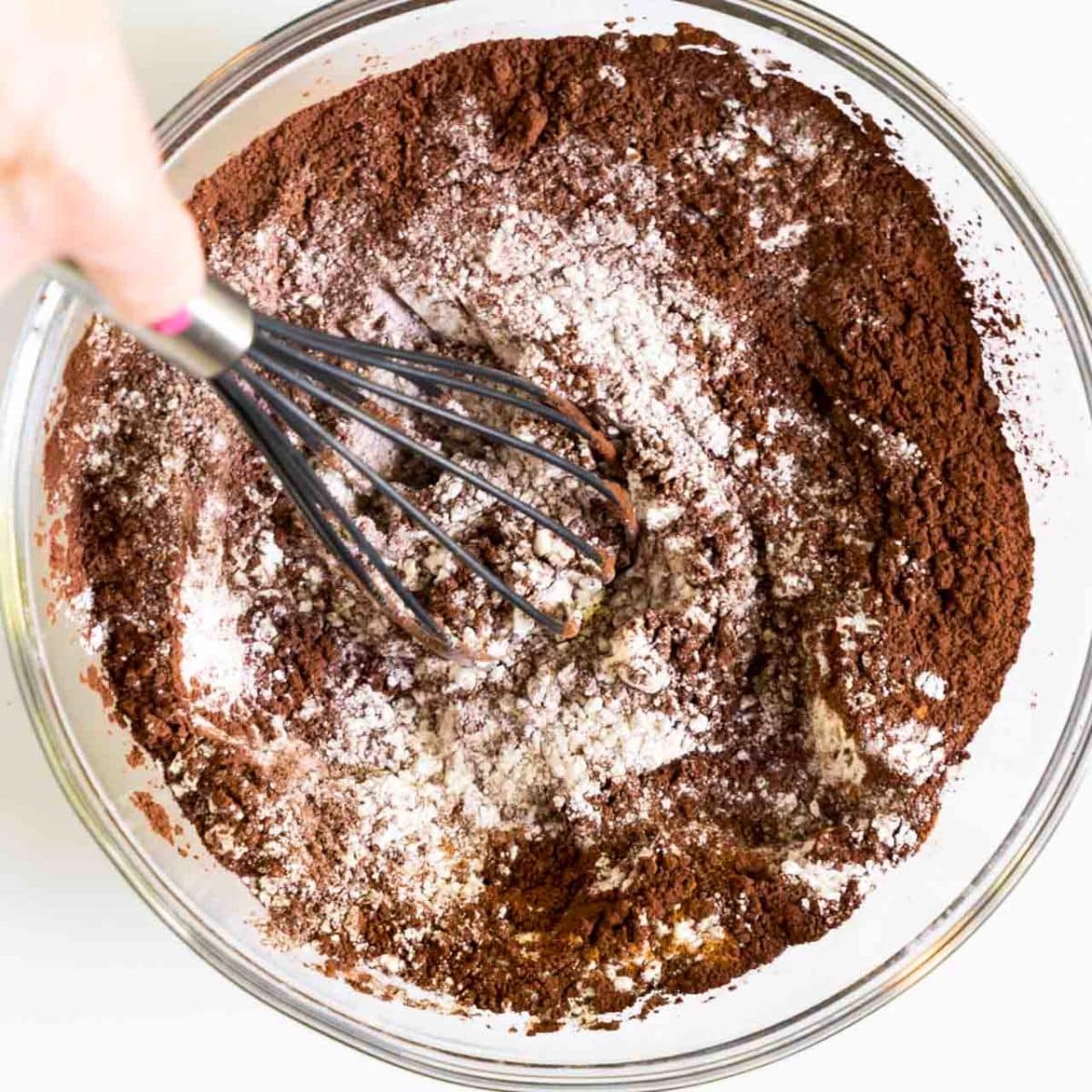 Dry ingredients whisked together in a bowl for chocolate pumpkin muffins. Hostess At Heart
