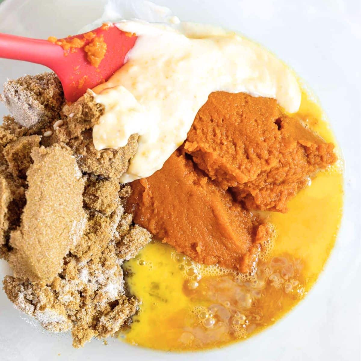 Wet ingredients for chocolate pumpkin muffin batter in a mixing bowl. Hostess At Heart