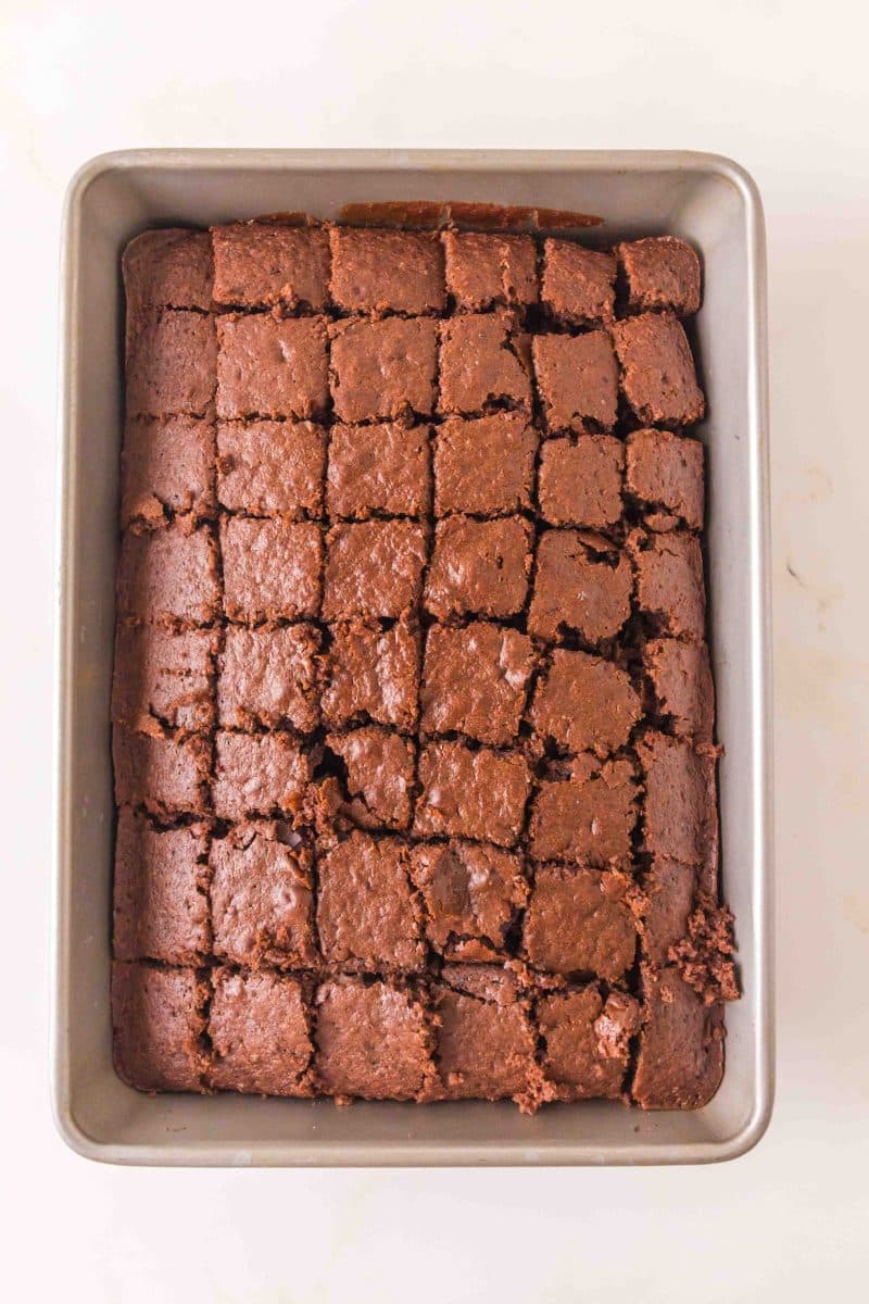 Overhead view of a chocolate cake cut into cubes to make a chocolate cake trifle dessert. Hostess At Heart