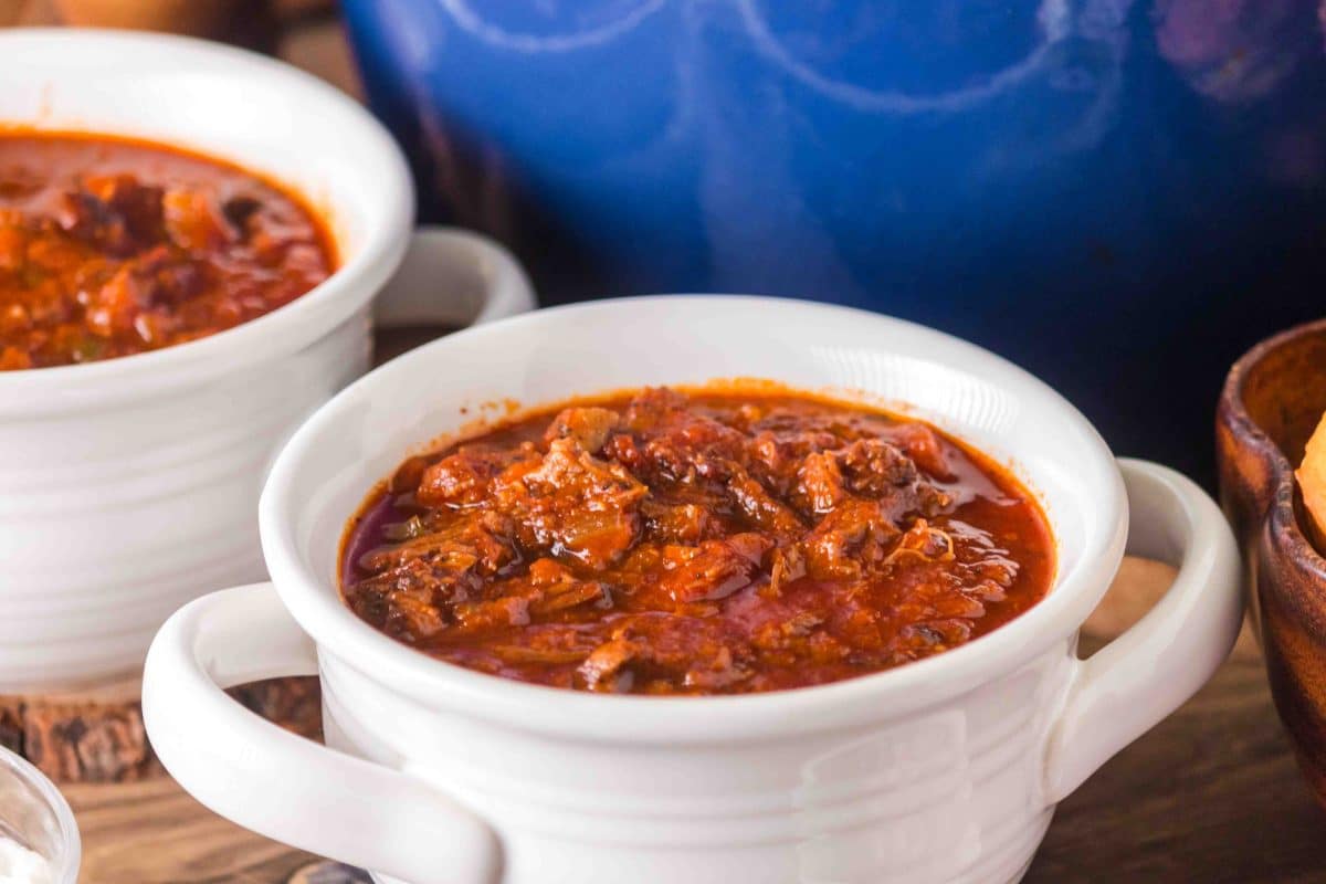 White soup bowls filled with homemade brisket chili made with brisket leftovers. Hostess At Heart