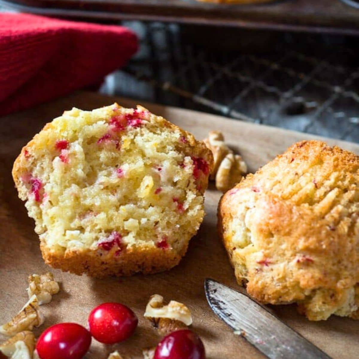 Cranberry orange muffins with golden brown tops and chopped cranberries. Hostess At Heart