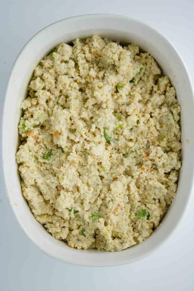 Top down view of a white baking dish filled with unbaked Southern cornbread dressing. Hostess At Heart