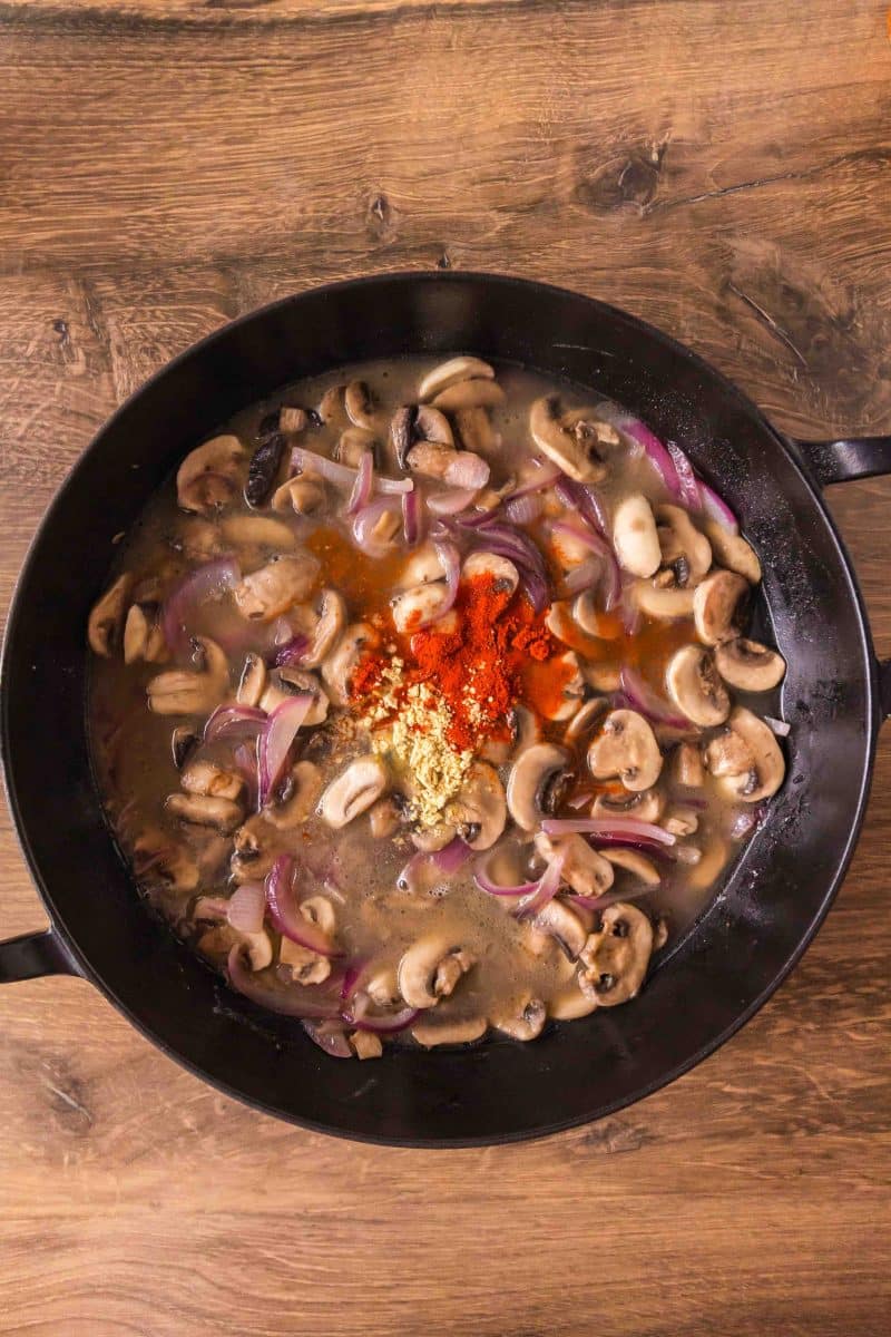 Broth and seasonings added to cooked mushrooms and onions in a skillet. Hostess At Heart