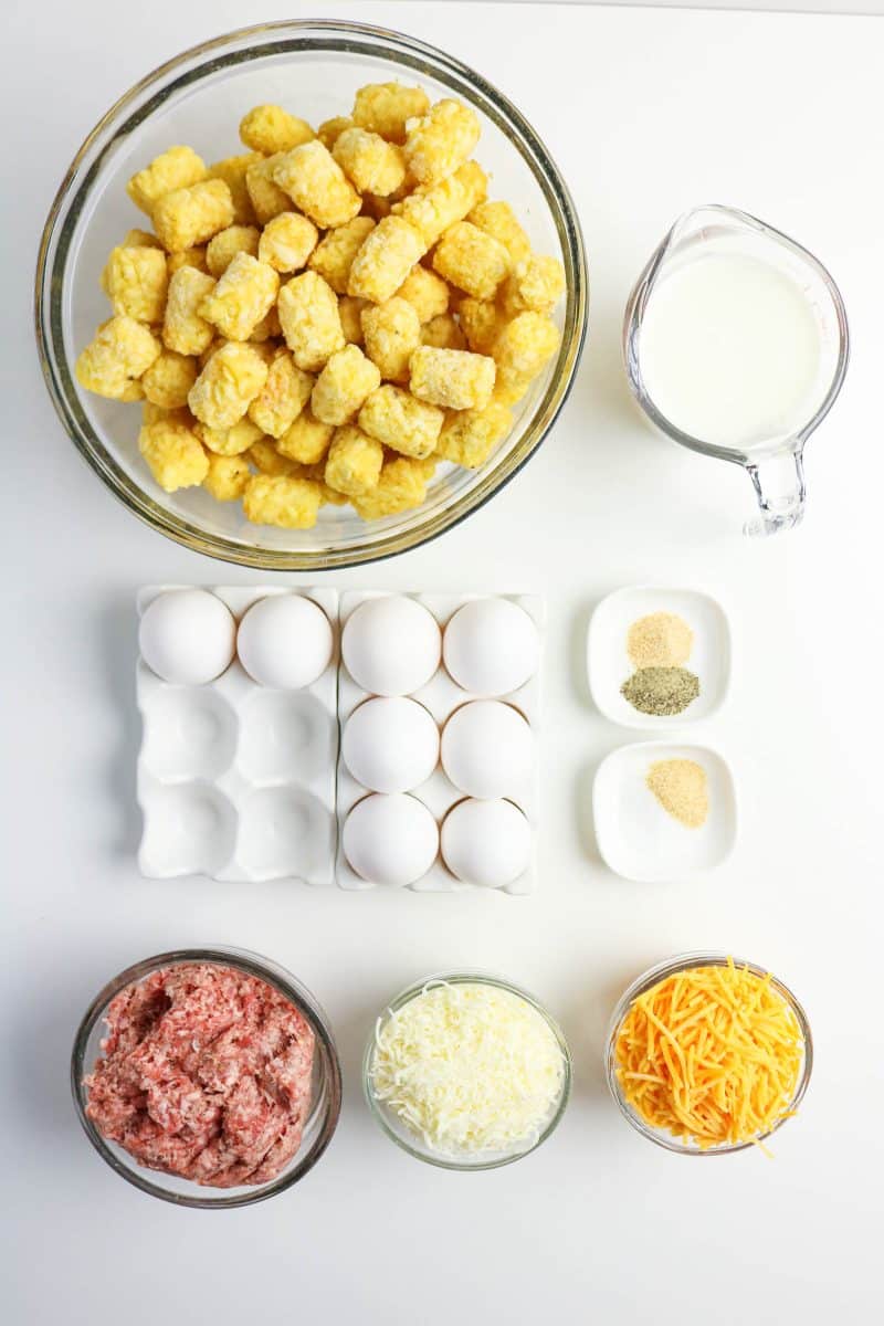 Tater Tot breakfast casserole recipe ingredients: Tater tots, sausage, cheese, eggs, milk, and spices. Hostess At Heart