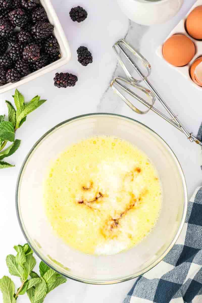A large mixing bowl filled with buttermilk, eggs, and vanilla mixed for the custard filling. Hostess At Heart