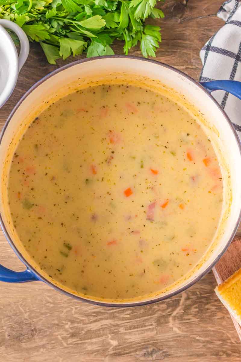 Creamy roux stirred into ham and potato soup in a Dutch oven. Hostess At Heart