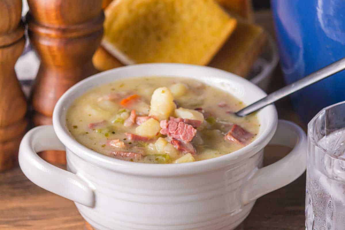 Bowl of creamy ham and potato soup with tender vegetables. Hostess At Heart