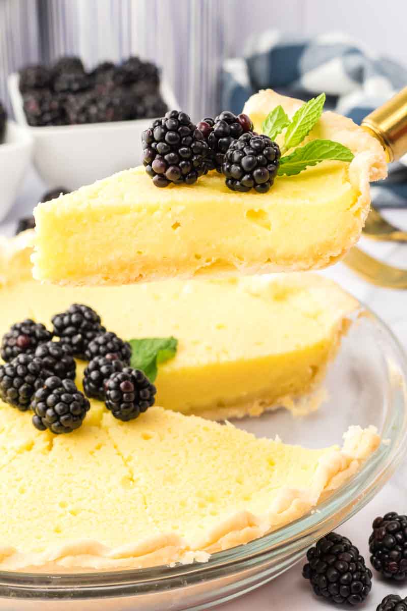Slice of buttermilk pie lifted from the pie on a pie server. Hostess At Heart