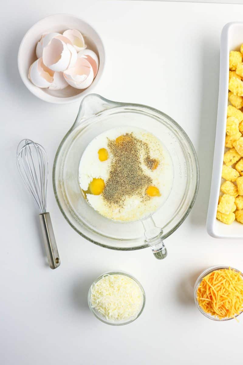Combined egg and milk mixture that will be poured over a tater tot breakfast casserole. Hostess At Heart