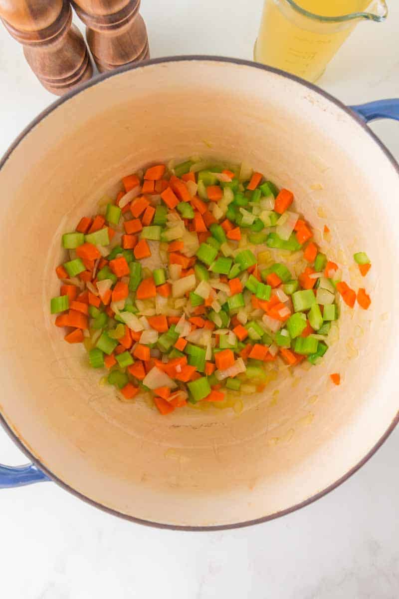 Carrots, celery and onion cooking in a Dutch oven. Hostess At Heart