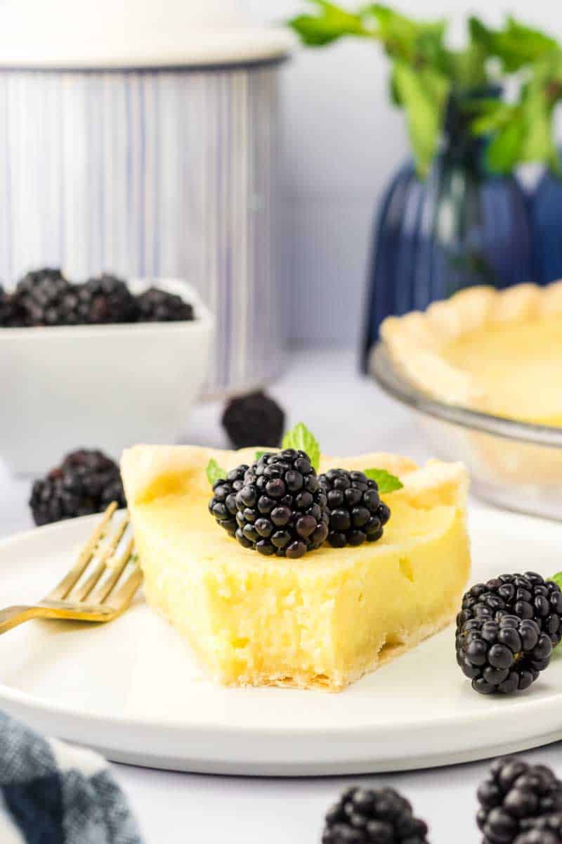 Slice of creamy buttermilk pie with a bite taken out. Hostess At Heart