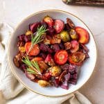 Roasted carrots, beets, and Brussels sprouts with pecans in a serving dish. Hostess At Heart