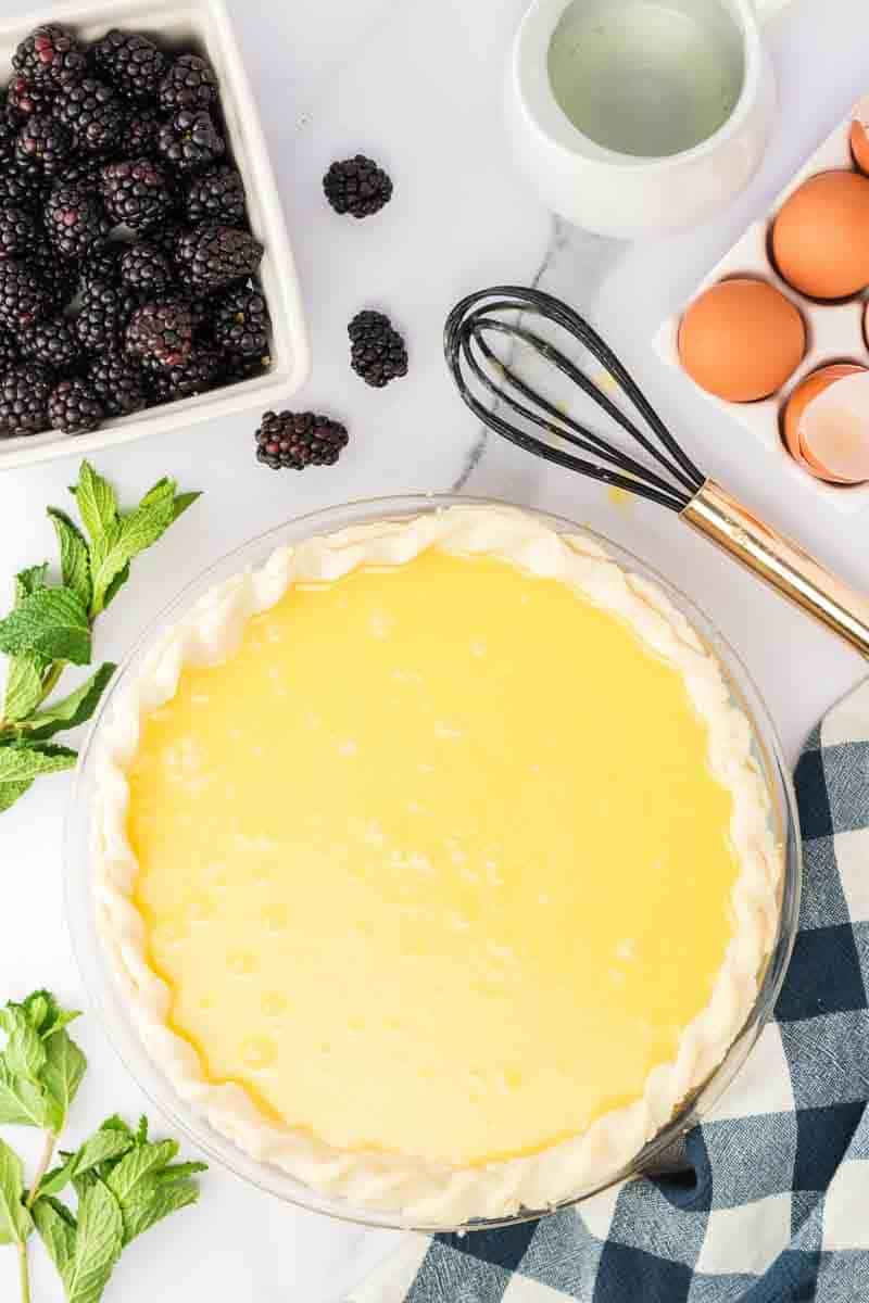 Buttermilk pie filling poured into the par-baked pie crust. Hostess At Heart