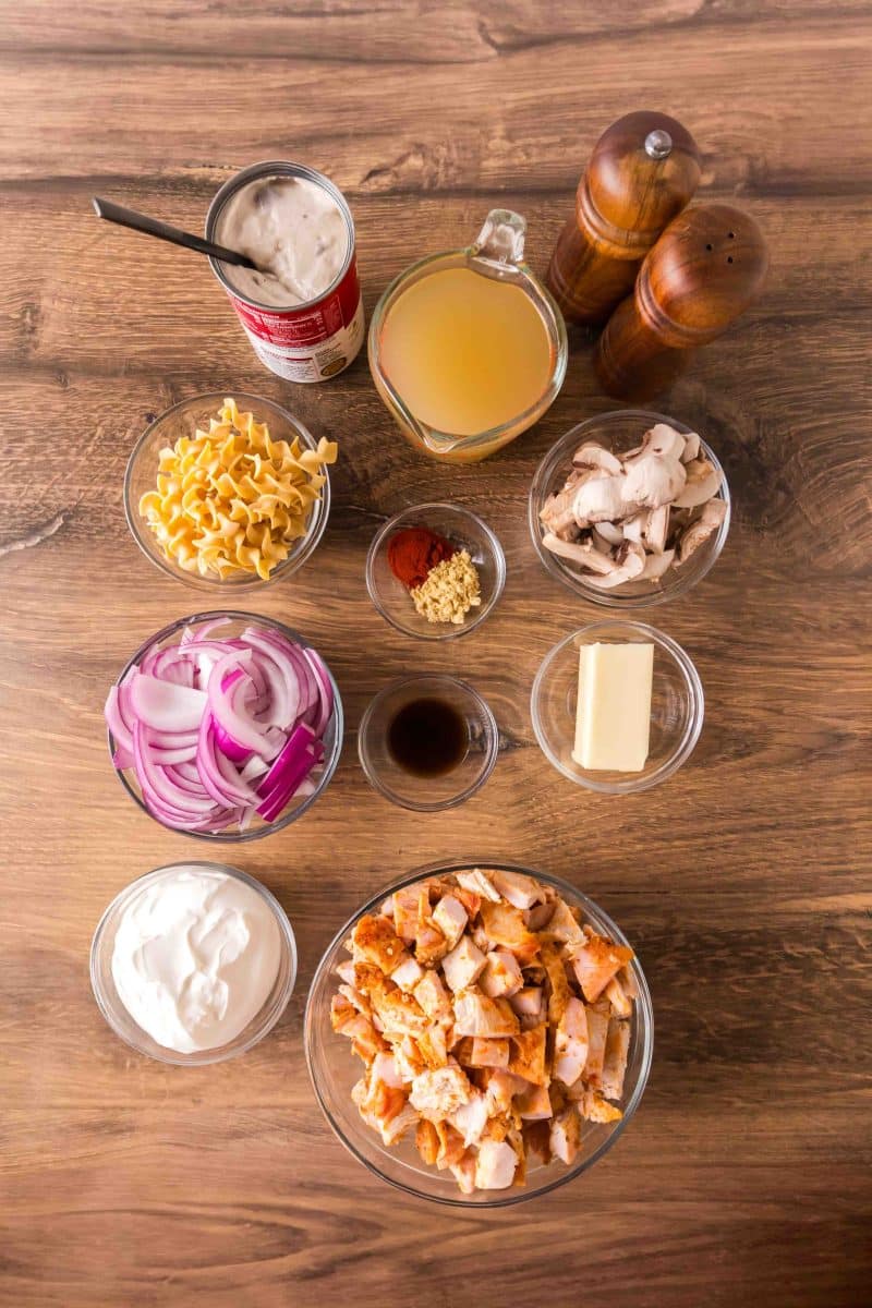 Turkey stroganoff ingredients: leftover diced turkey, red onion, mushrooms, sour cream, butter, egg noodles, cream of mushroom soup, chicken broth, worcestershire sauce, paprika, and dry mustard. Hostess At Heart