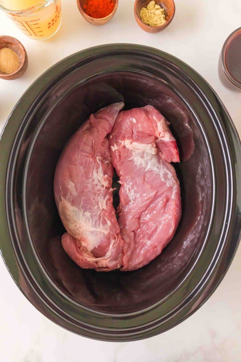 Raw pork tenderloins in a slow cooker. Hostess At Heart